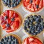 Overhead shot of mini strawberry and blueberry tarts.
