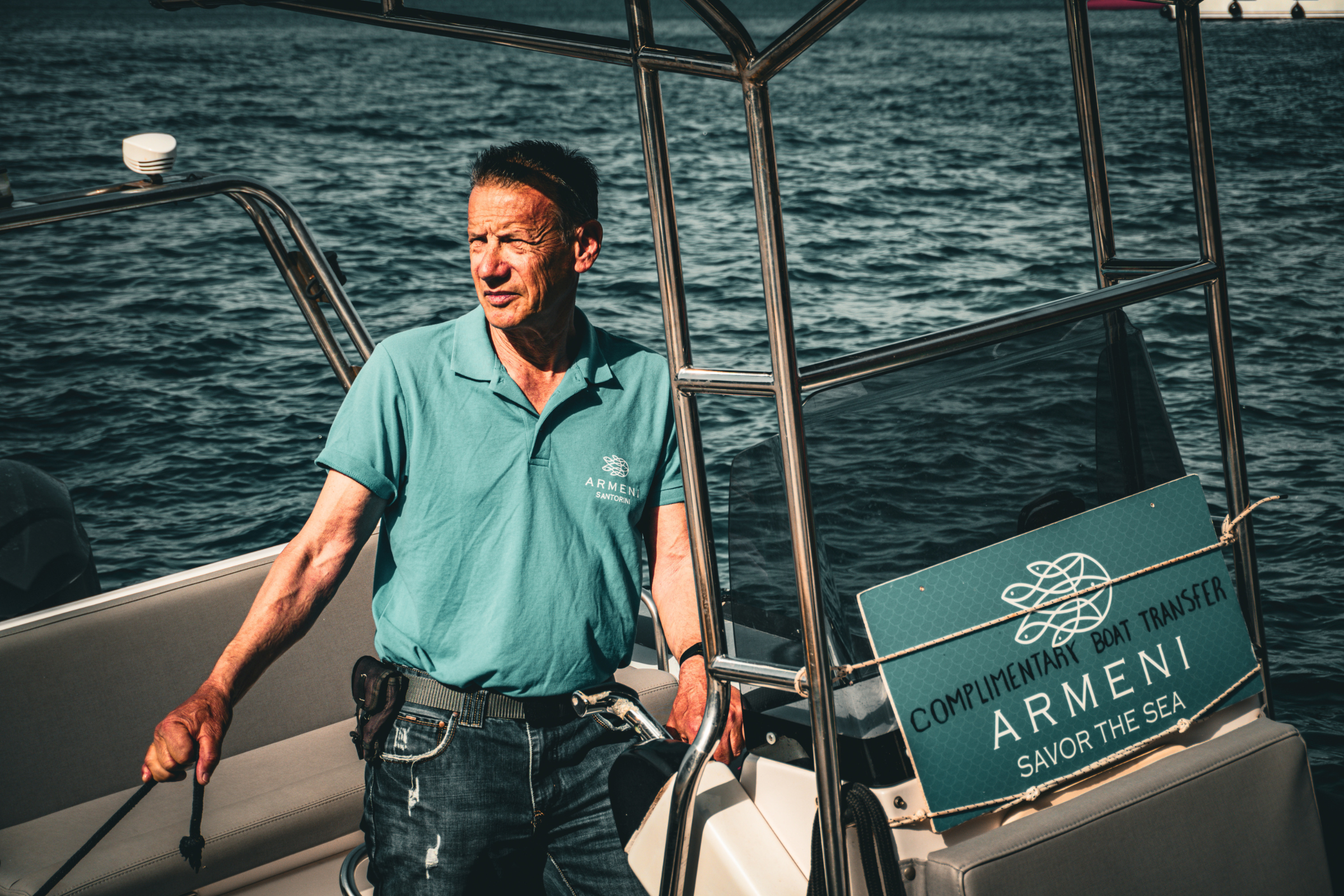 Man standing in boat for dining at Armeni