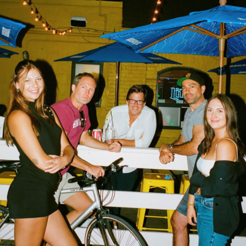 Group of attractive people standing outside Penny's patio in toronto