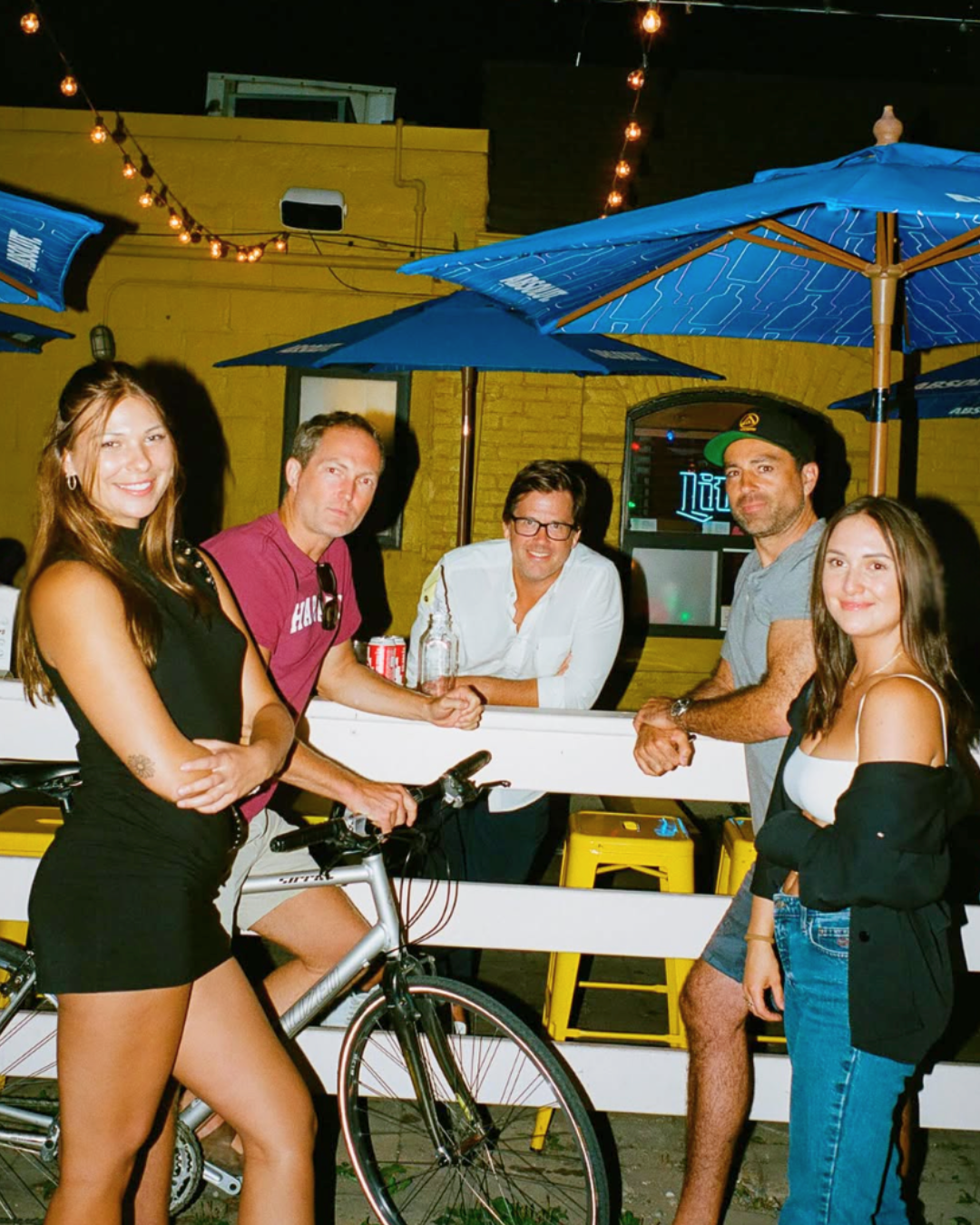 Group of attractive people standing outside Penny's patio in toronto