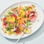Shaved carrot, asparagus and beet salad dressed with pistachios and creamy dressing in a rainbow and goat cheese salad