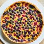 Cherry and berry clafoutis tart with sweet-tart cherries, blueberries and baked vanilla custard in a buttery pastry shell.